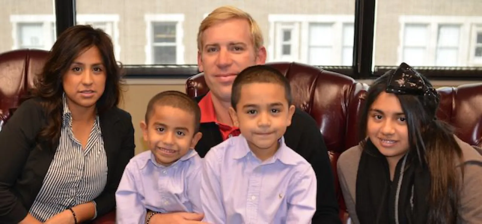 A VB Attorneys lawyer seated with a client and her three children