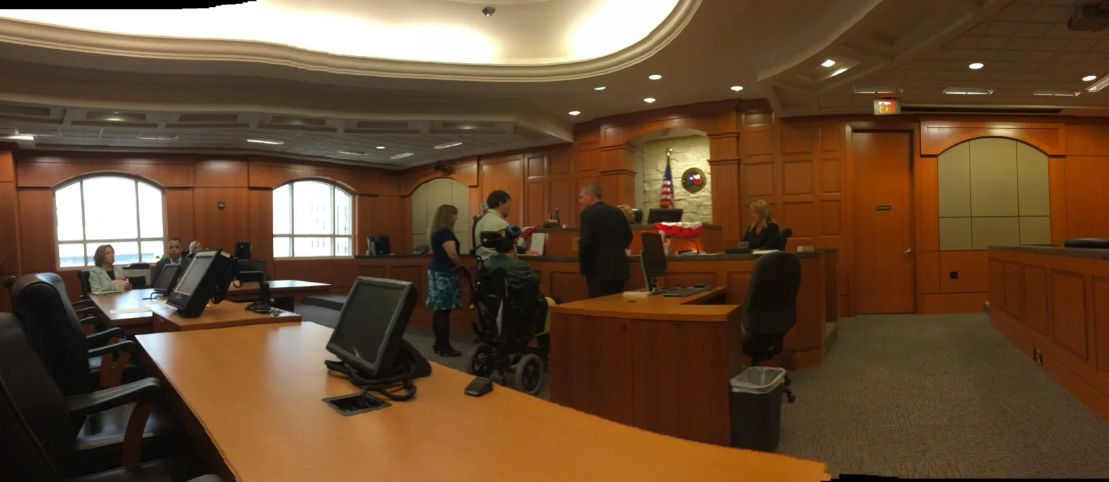 A client using a wheelchair at the counsel table during a courtroom proceeding