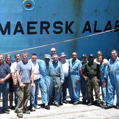 Maersk Alabama crew in front of the ship