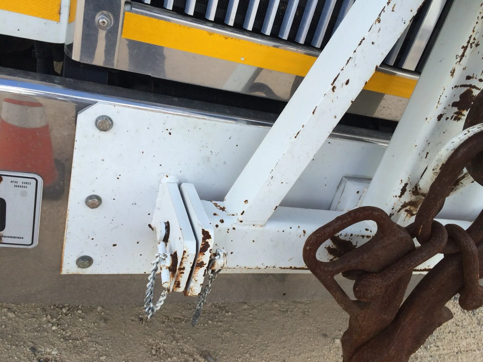 Rusted rigging chain and hook on a crane outrigger