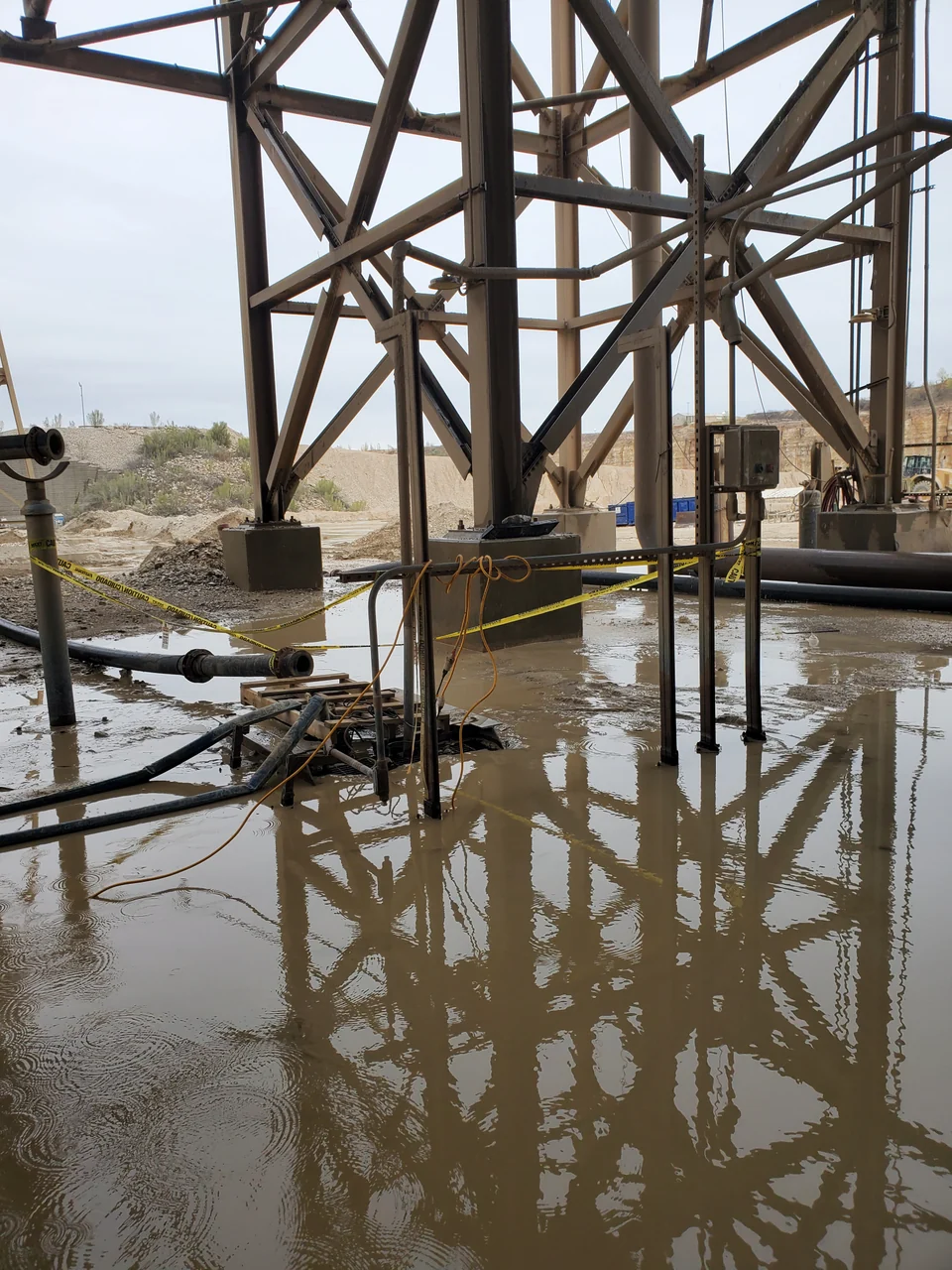 Steel supports and pipework above standing water at the quarry inspection.