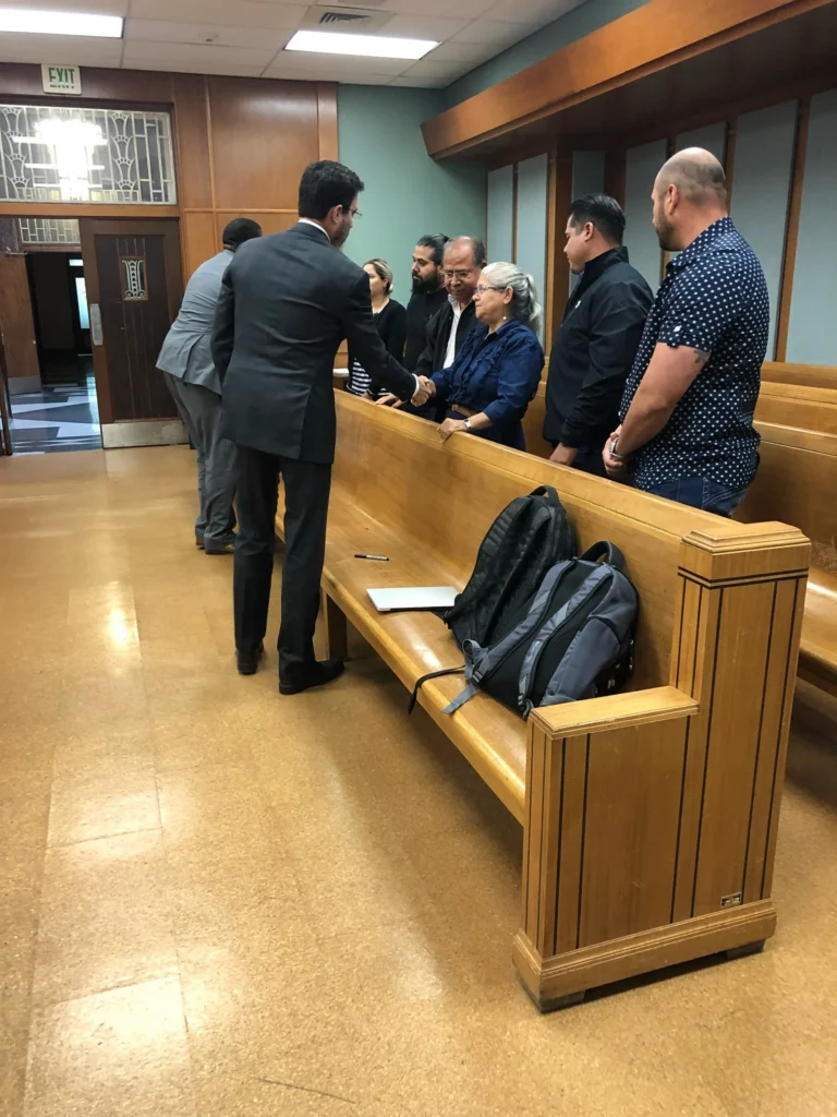 People shake hands beside the jury box after the Barron refinery case Verdict.