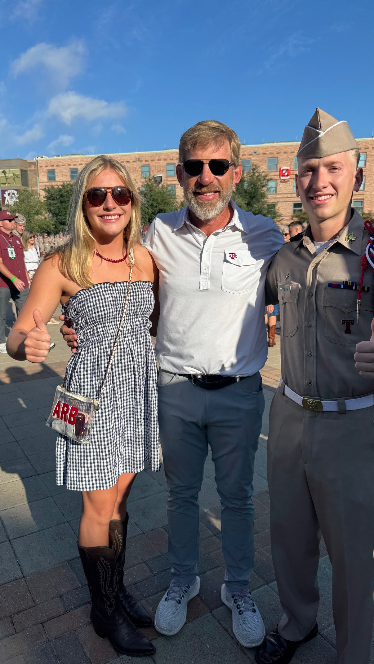 Brian Beckcom with Addie at left and Henry at right, wearing a Texas A&M Corps of Cadets uniform.