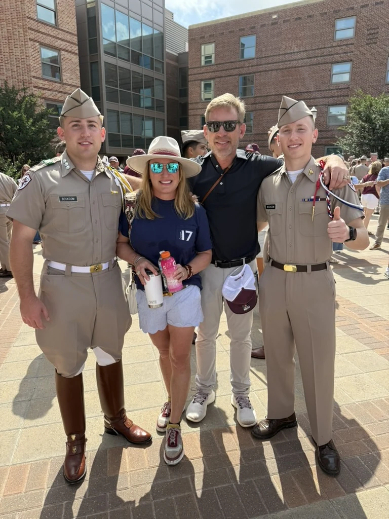 Gus Beckcom, Cara Beckcom, Brian Beckcom, and Henry Beckcom standing together, with Gus and Henry in Corps of Cadets uniforms.