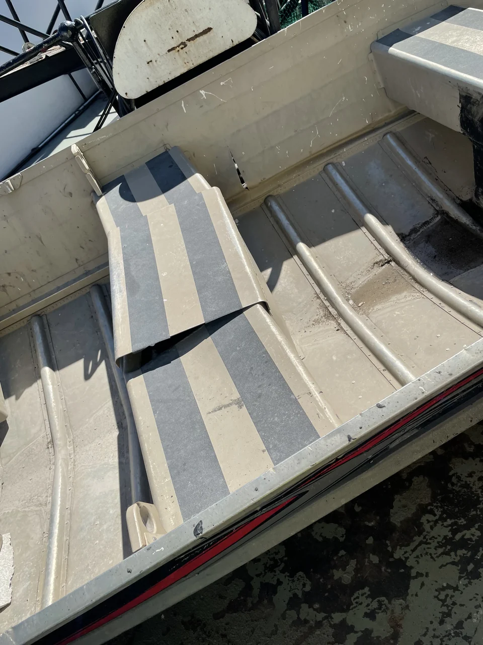 Close view of a bench seat and the interior floor of the workboat.