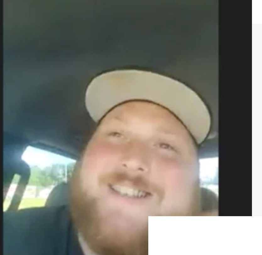 Devin S. wearing a cap and smiling.