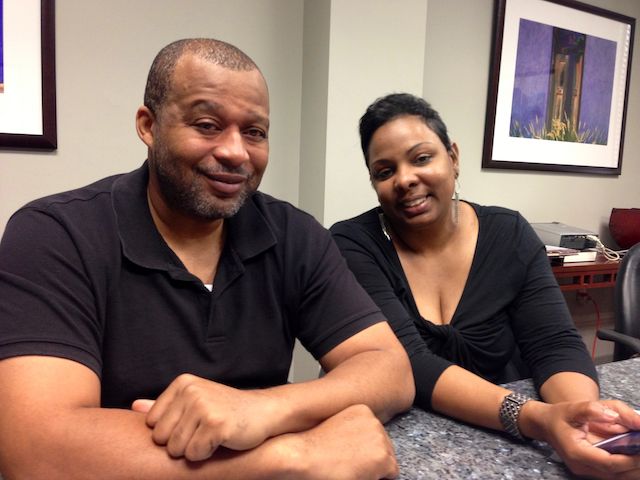 Elvern J. and Tiffany seated together at an office table.