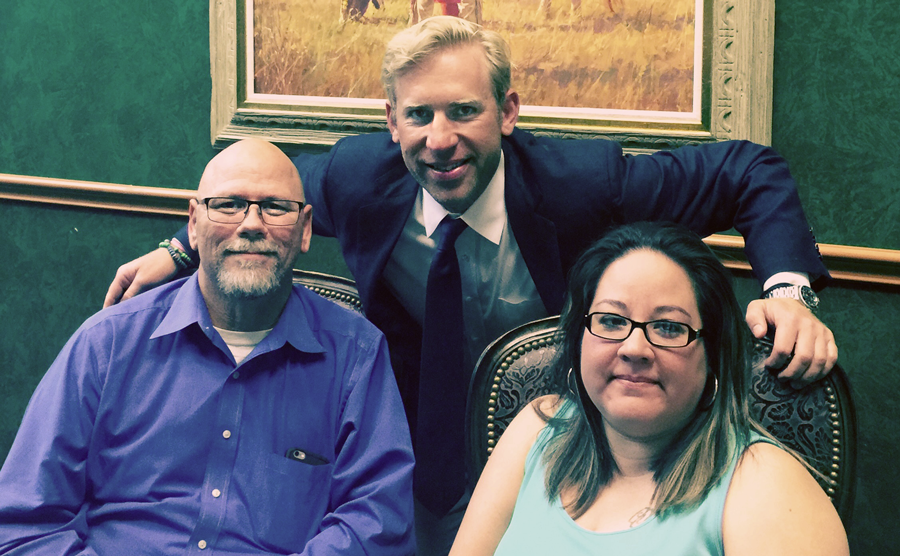Gene A. and Nicollette seated with Brian Beckcom standing behind them.