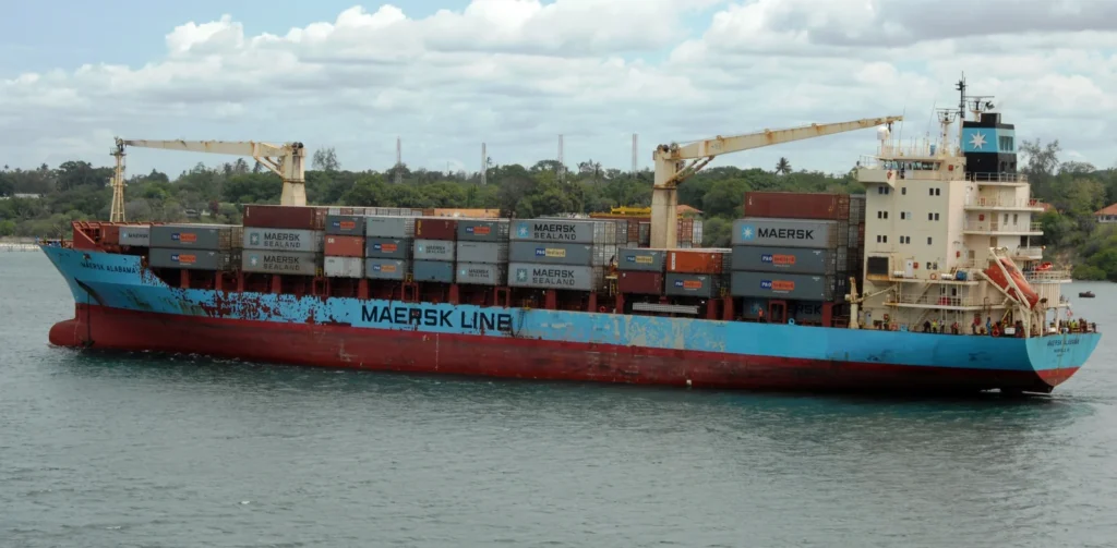 The Maersk Alabama container ship leaving Mombasa, Kenya, with containers and deck cranes visible.