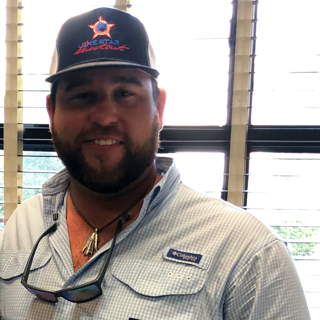 Nick E. wearing a cap in an office portrait.